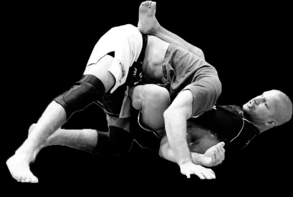 Head instructor Paul Creighton demonstrating a guillotine choke on his student from the bottom position.