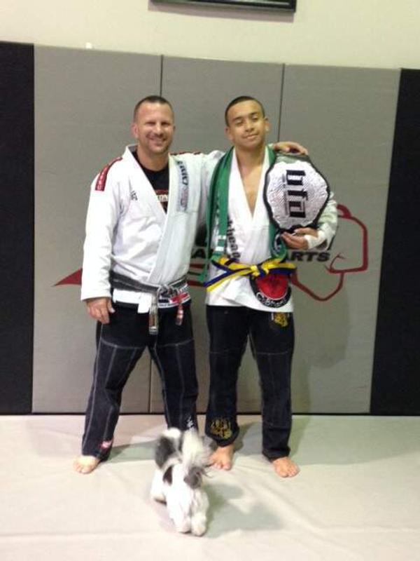 Logan Santos receives our highest junior rank (BLUE/YELLOW BELT)!!